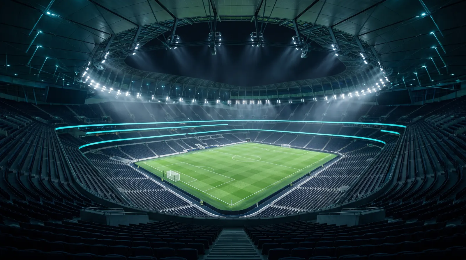 ナイター照明が灯る無人のサッカースタジアムを上段から見下ろしたイメージ